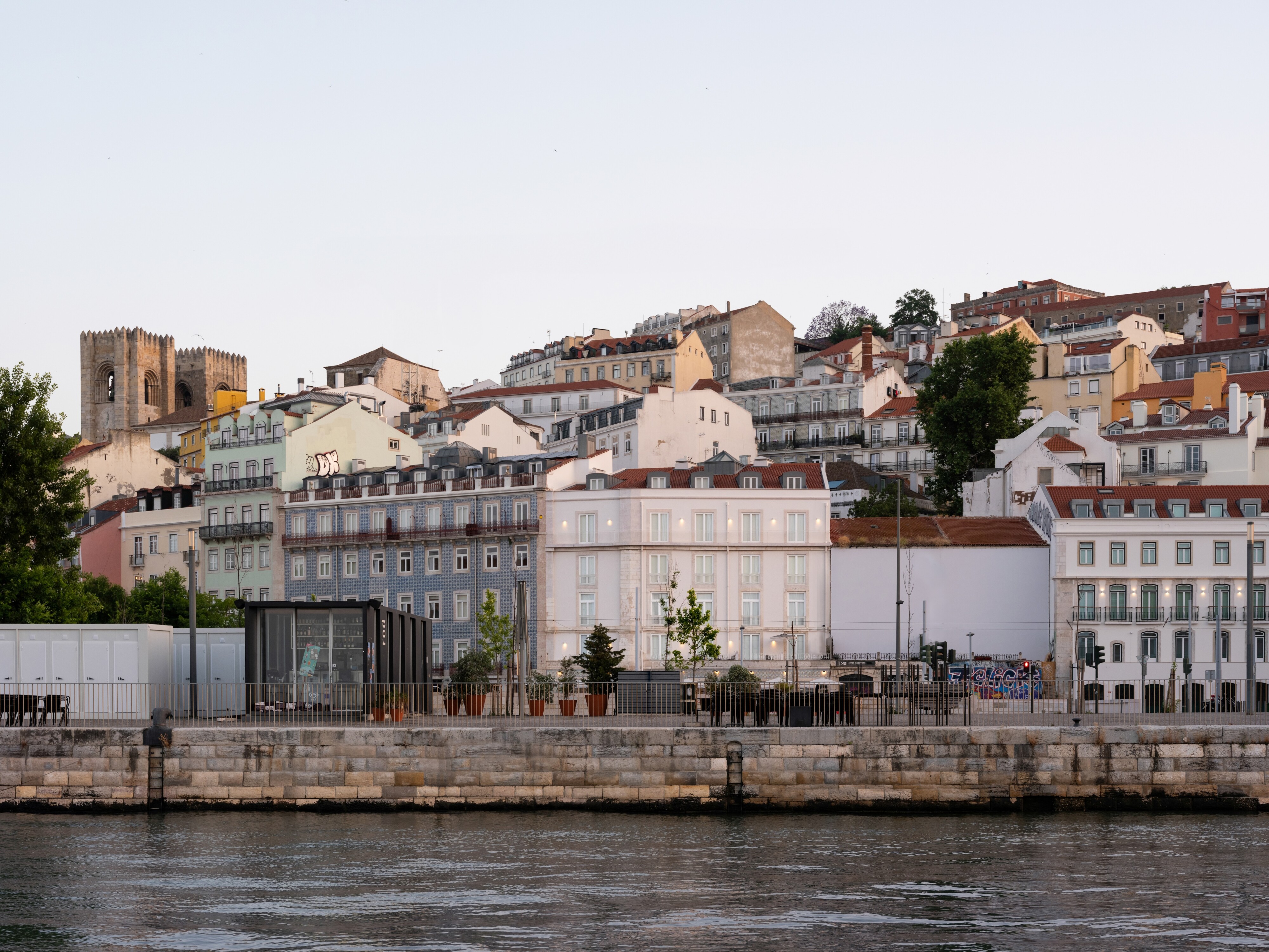 The houses of Alfama rising above the riverside, seen across the Tagus near LIOZ Lisboa